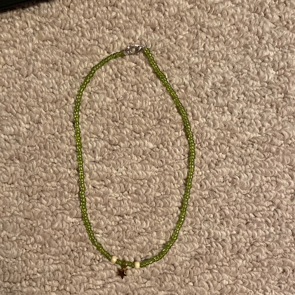 green necklace and a star charm